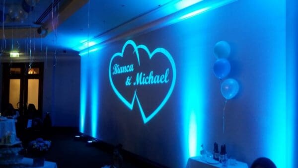 A room with blue lights and two hearts on the wall