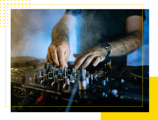 A man is playing some music on the sound board