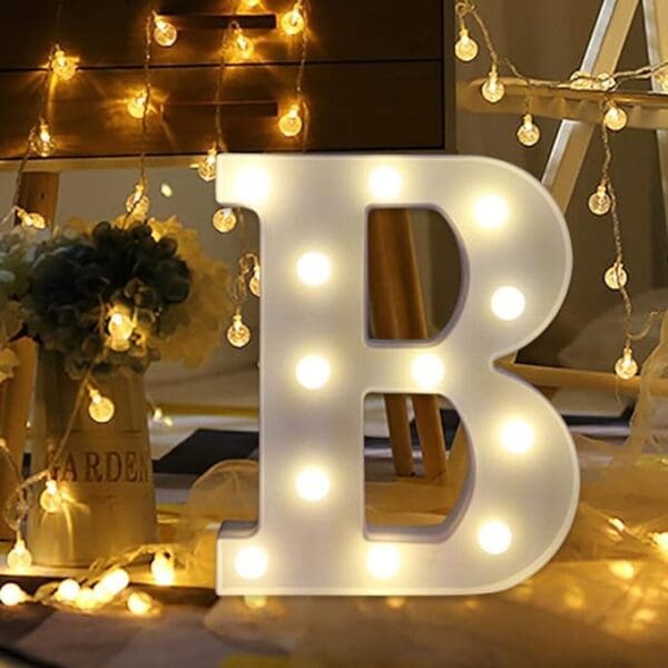 A lighted letter b sitting on top of a table.