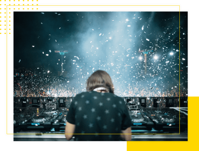 A person with headphones sitting in front of a stage.