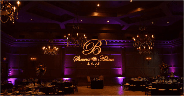 A large room with purple lighting and a monogram.